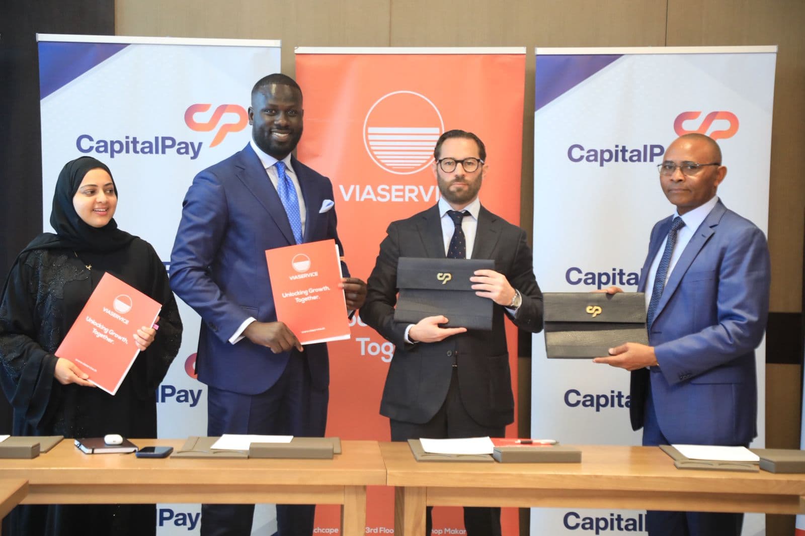 Capital Pay International and Viaservice executives at a partnership signing