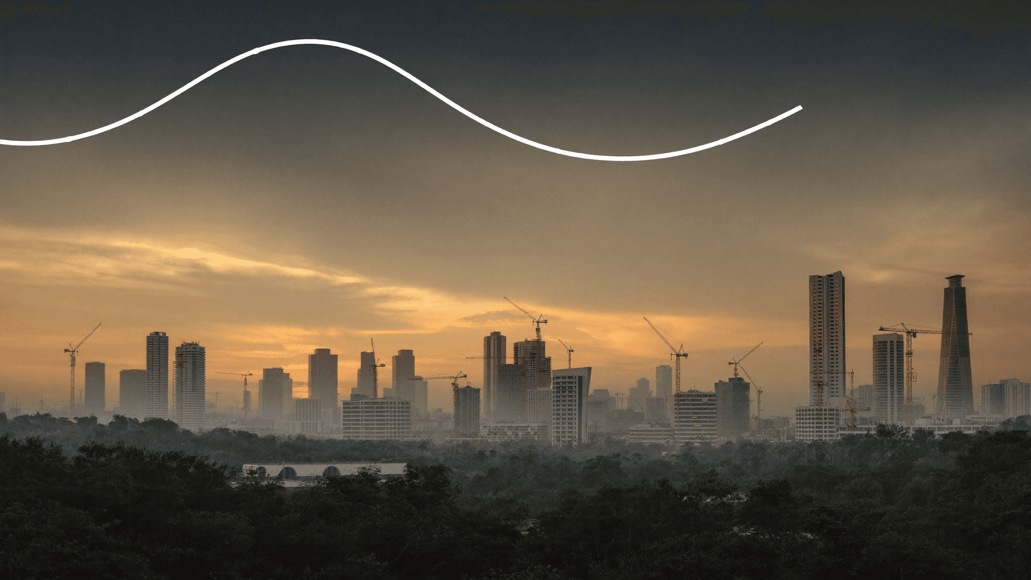 A developing city skyline at sunrise (illustration)