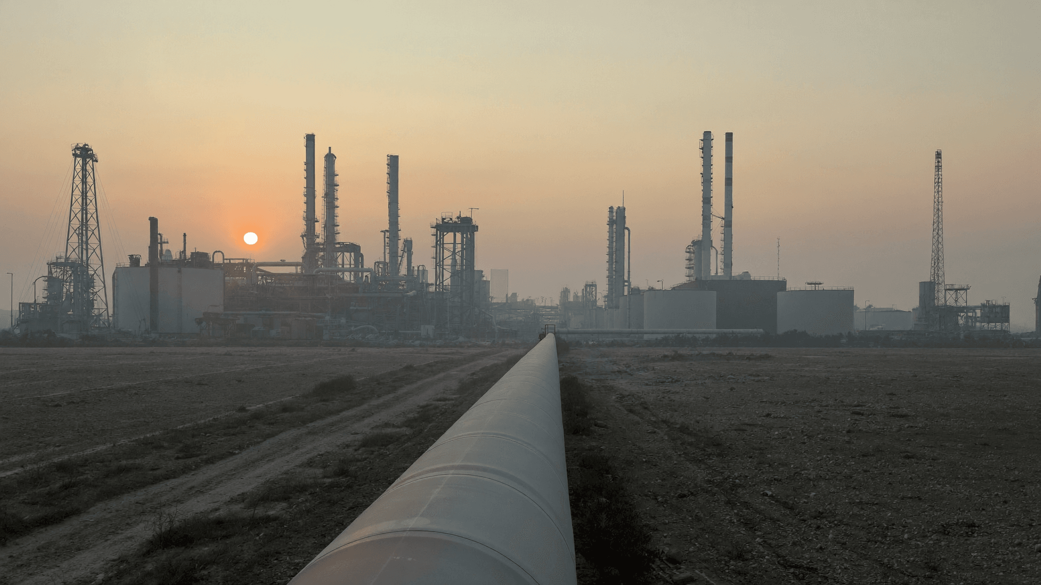 Oil refinery and pipeline at dawn (illustration)